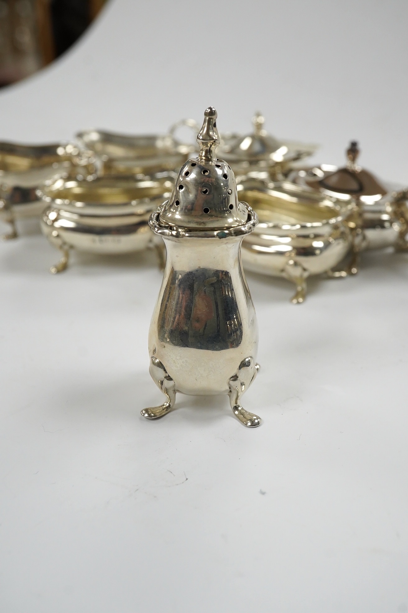 Eight assorted silver cruets including salts and mustard pots, various dates and makers, Condition - poor to fair